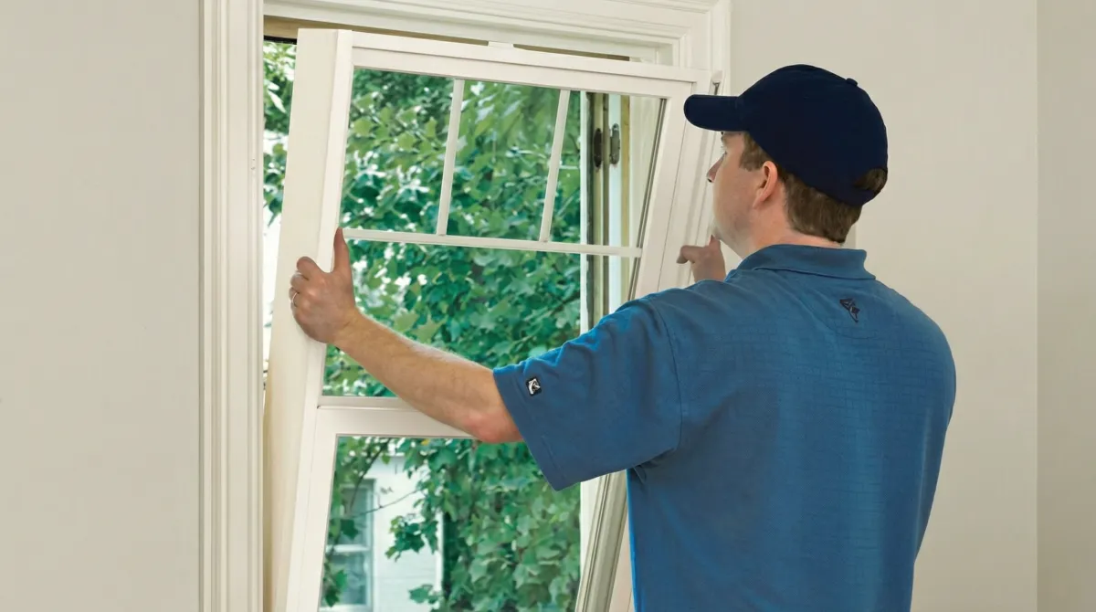 Professional contractors performing a residential window insulation and replacement service in Detroit, Mi